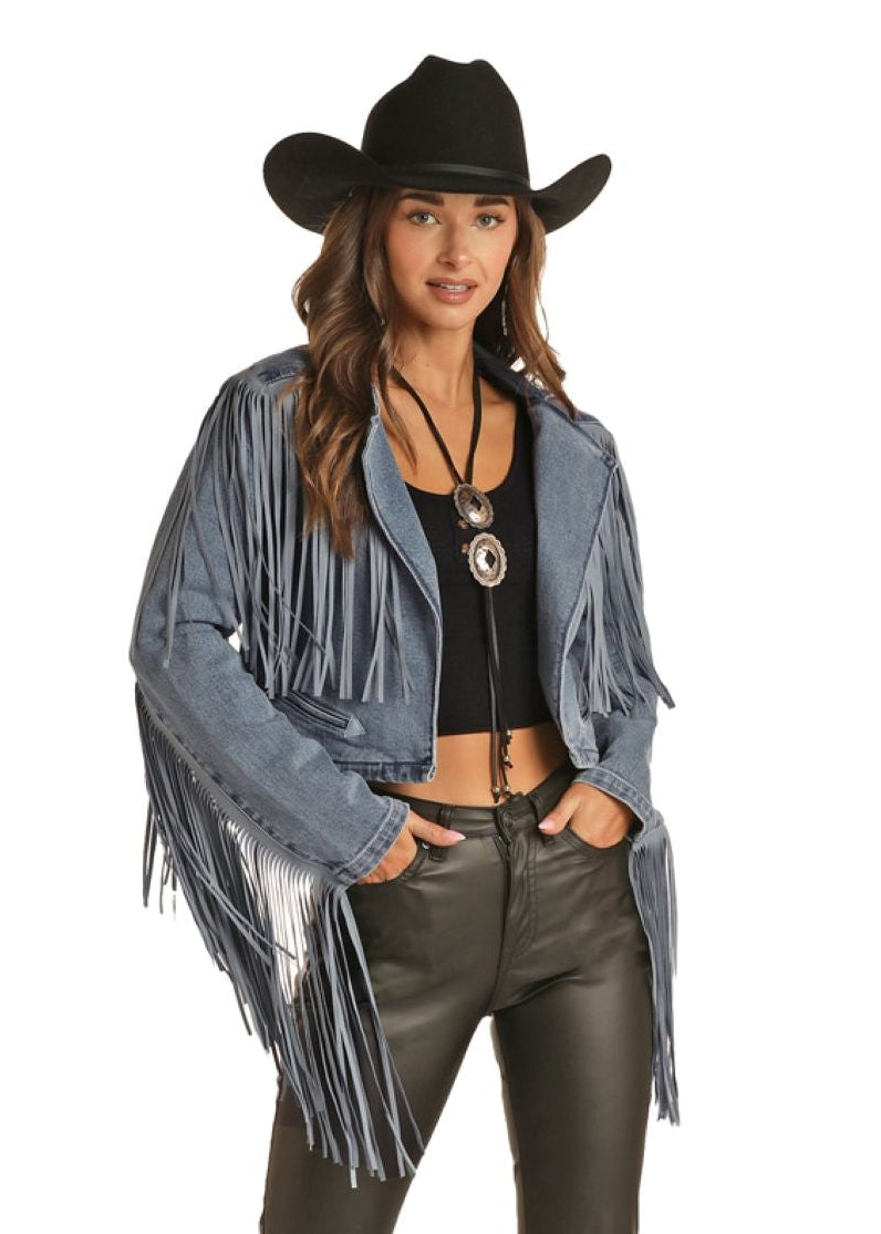Person wearing a denim fringe jacket, leather pants, and a cowboy hat on a white background