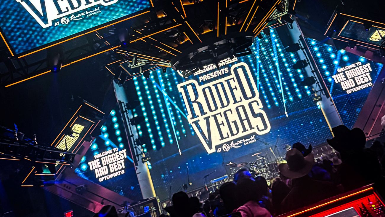 Large screen displaying 'Rodeo Vegas' with a crowd in the foreground at night.