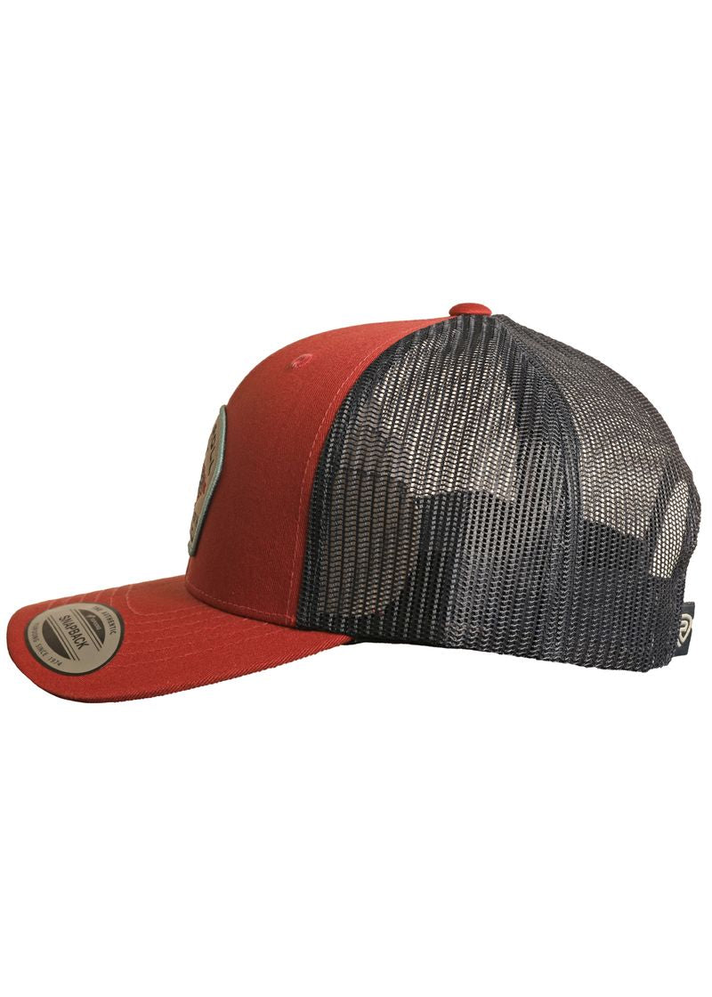 The Rock & Roll Red Aztec Cap by Rock & Roll Denim features red front panels and a flat brim, contrasting with a black mesh back. Viewed from the side, it includes an adjustable snapback and branded stickers on the brim.