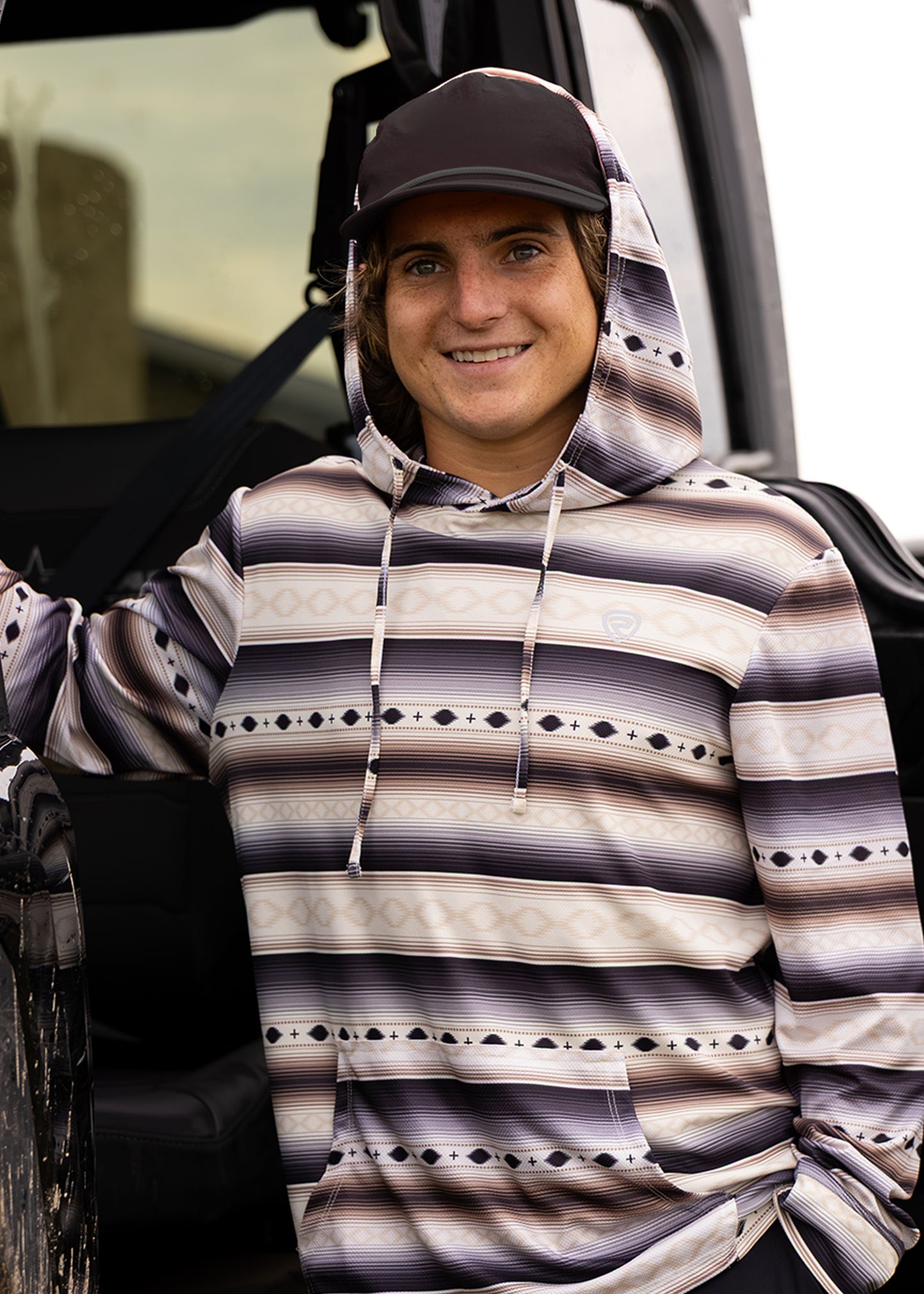 Rocker Steiner wearing an aztec stripe performance hoodie. 