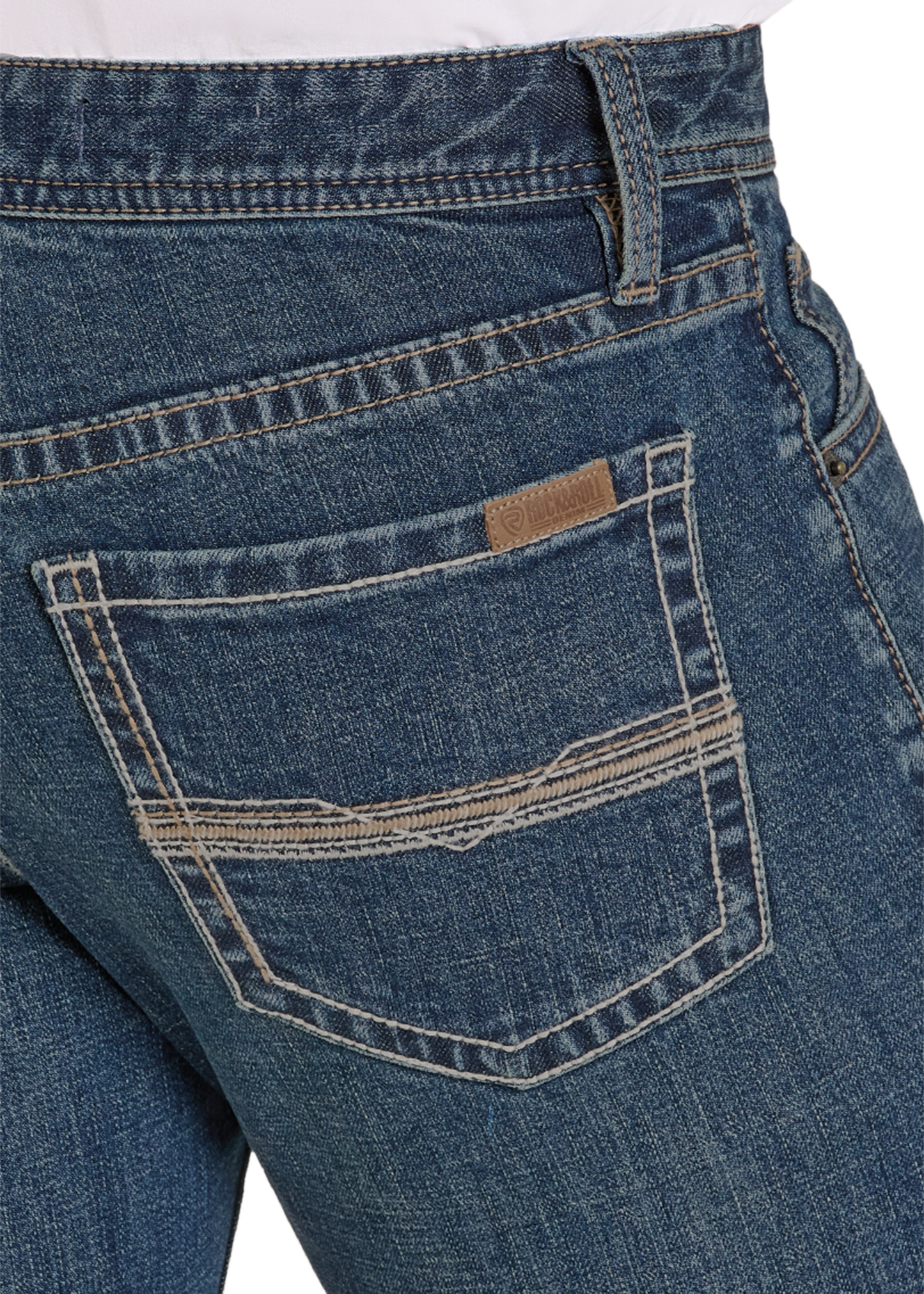 Close-up of blue jeans with a brand label on the pocket against a white background