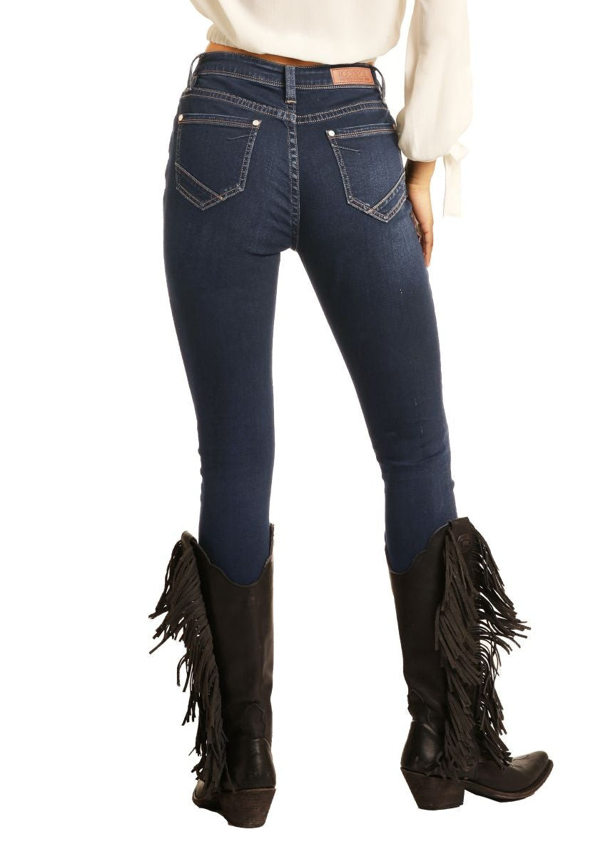 Woman wearing a white shirt, blue jeans, and black cowboy hat on a white background