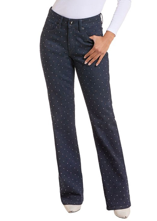 Woman wearing dark wash studded bootcut jeans. 