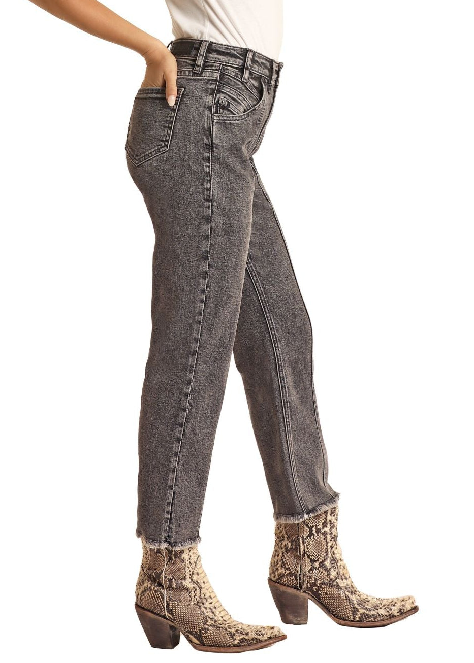 Woman wearing a white shirt, gray jeans, and cowboy hat on a white background