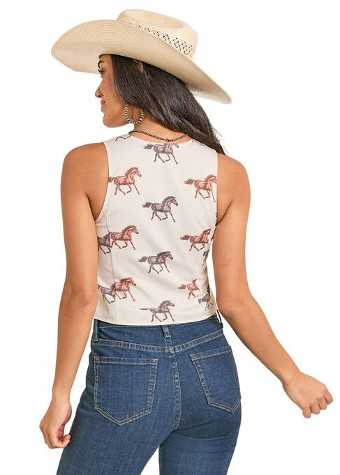 Woman wearing a sleeveless top with horse pattern and blue jeans on a white background