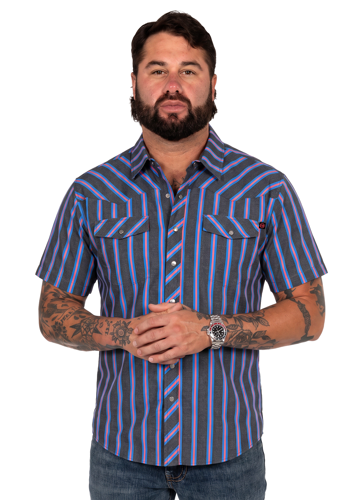 Koe Wetzel wearing a short-sleeve button-up shirt with vertical blue, purple, and gray stripes, paired with blue jeans, photographed against a solid white background.