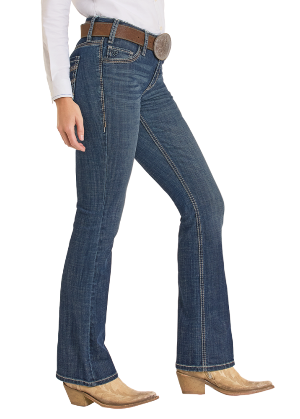 Woman wearing a white shirt, blue jeans, and a beige cowboy hat on a white background