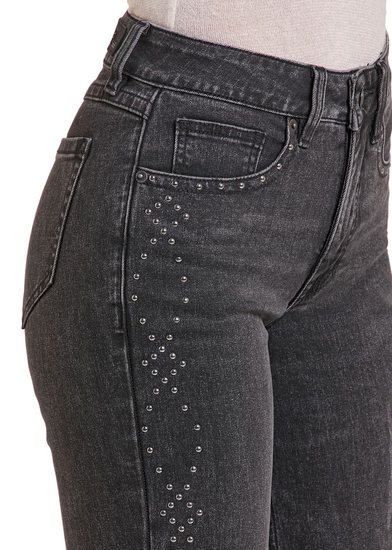 Detailed image of a studded design on Woman's black jeans. 