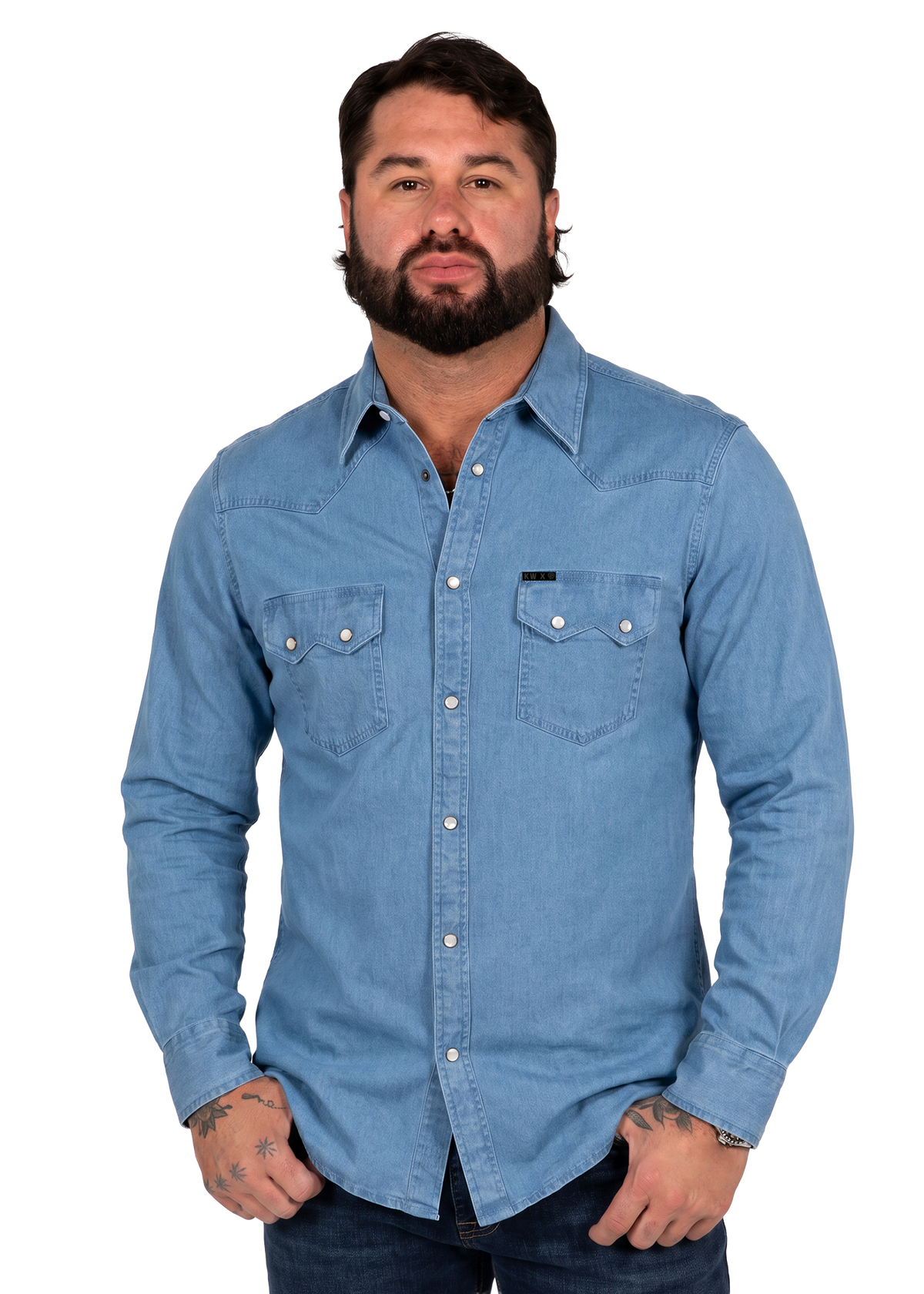 Koe Wetzel wearing a light blue denim long-sleeve western button-down shirt with two chest pockets, shown against a plain white background.