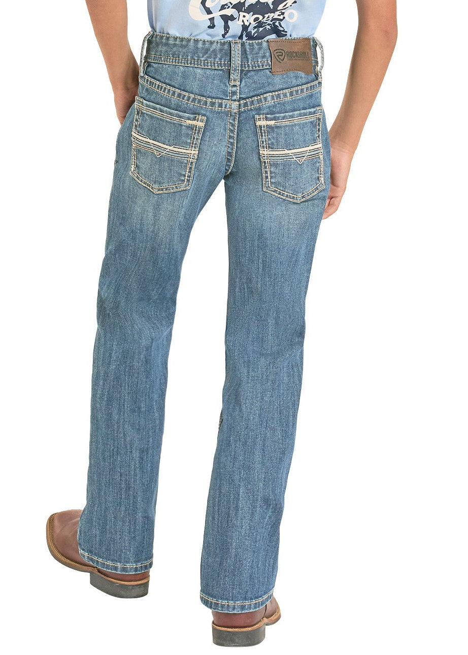 Person wearing a light blue t-shirt with graphic design and jeans, standing against a white background