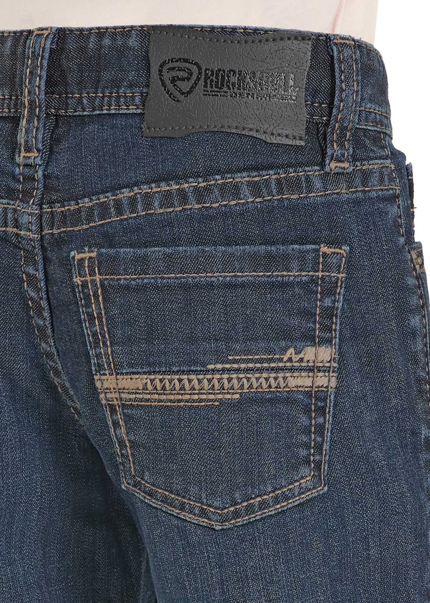 Close-up of blue jeans with a brand label on the back pocket.