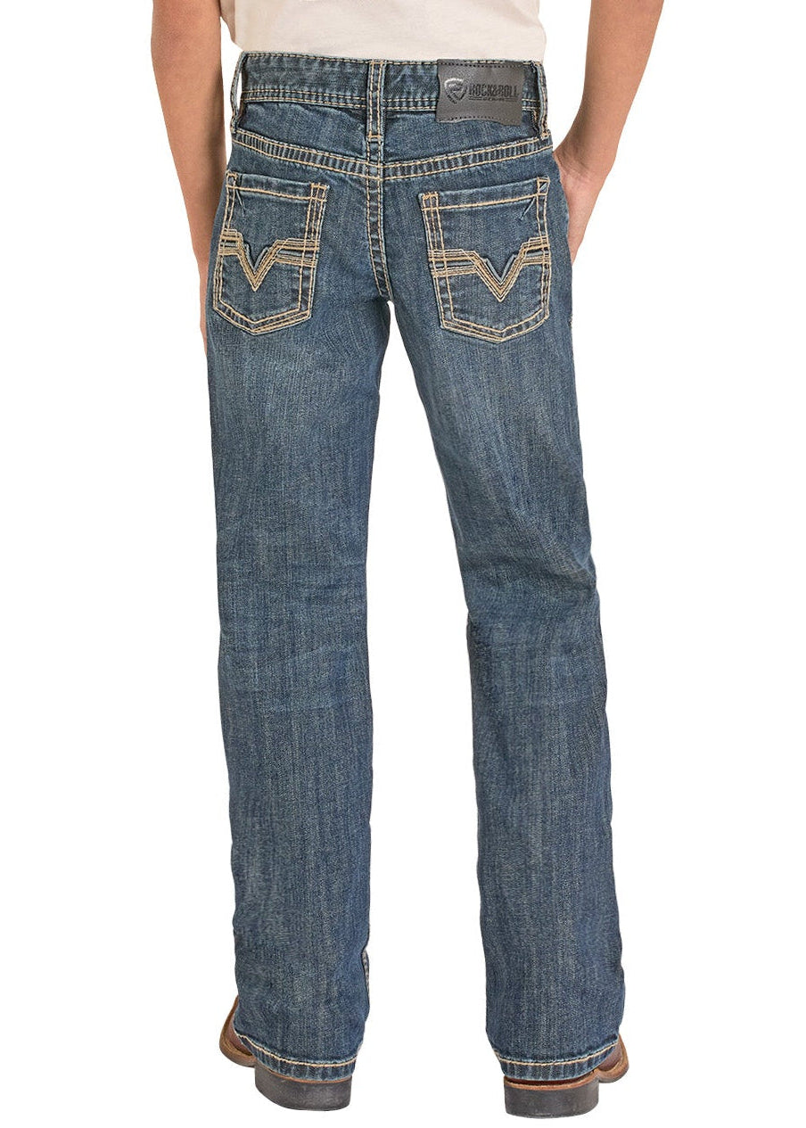 Boy wearing a white t-shirt with graphic design and blue jeans, standing against a white background