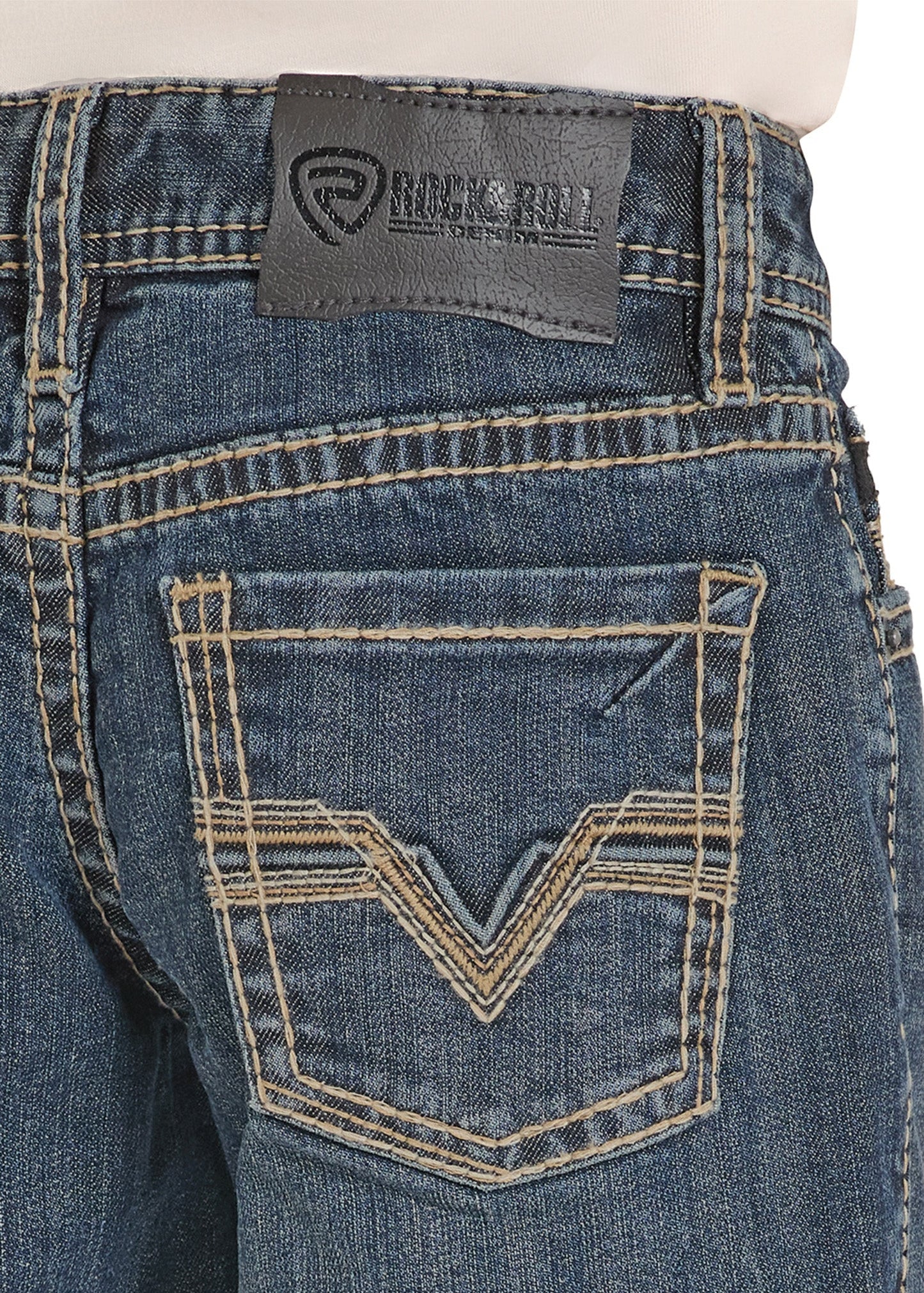 Close-up of blue jeans with a brand label on the back pocket against a white background