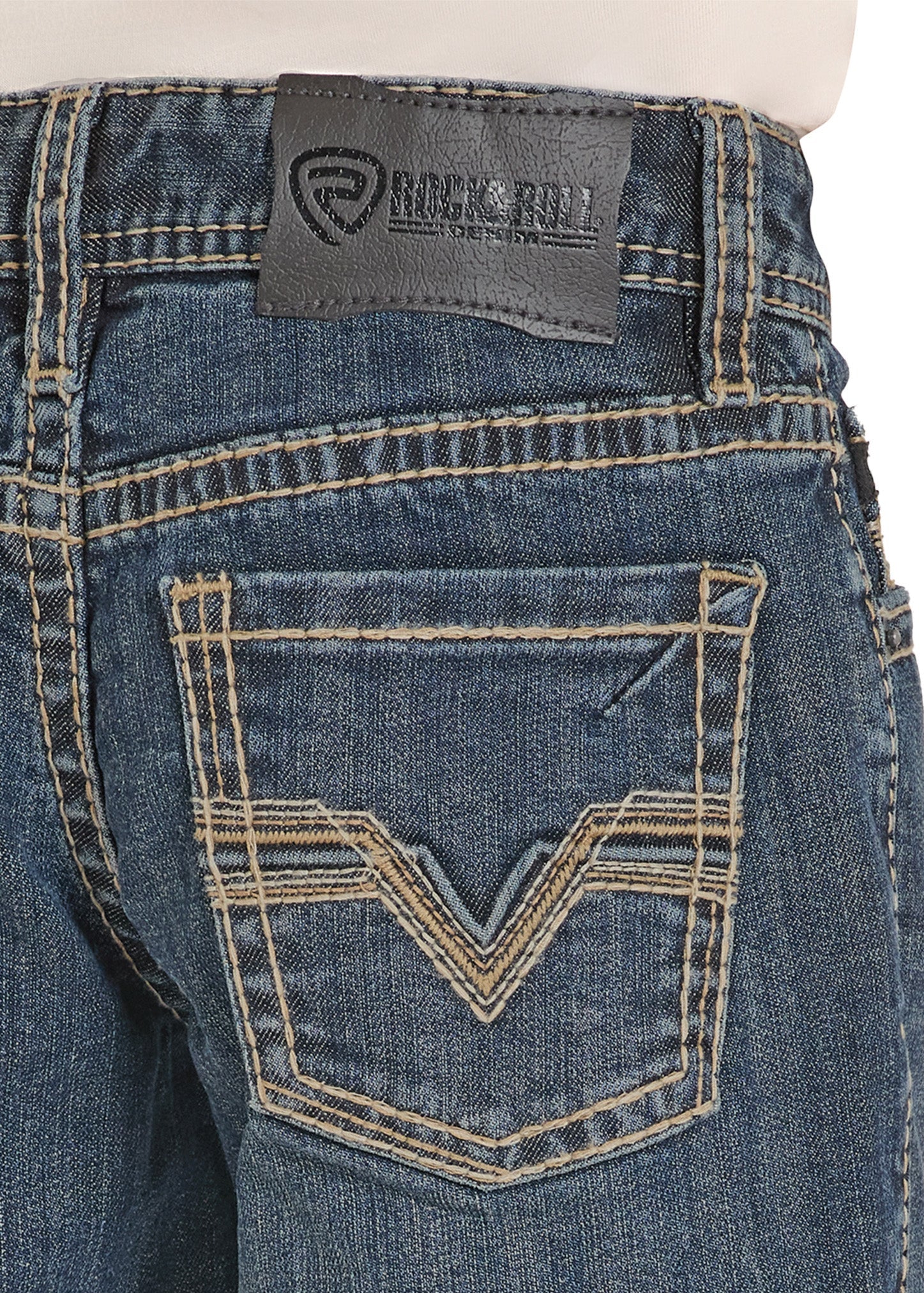 Close-up of blue jeans with a brand label on the back pocket against a white background