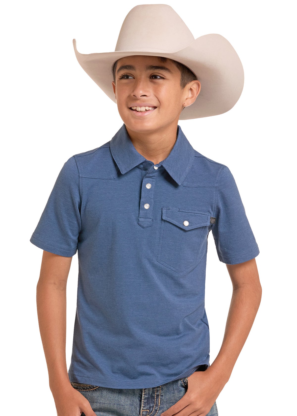 A smiling young man wearing a blue short-sleeve western polo shirt and a light beige cowboy hat, posed against a solid white background.
