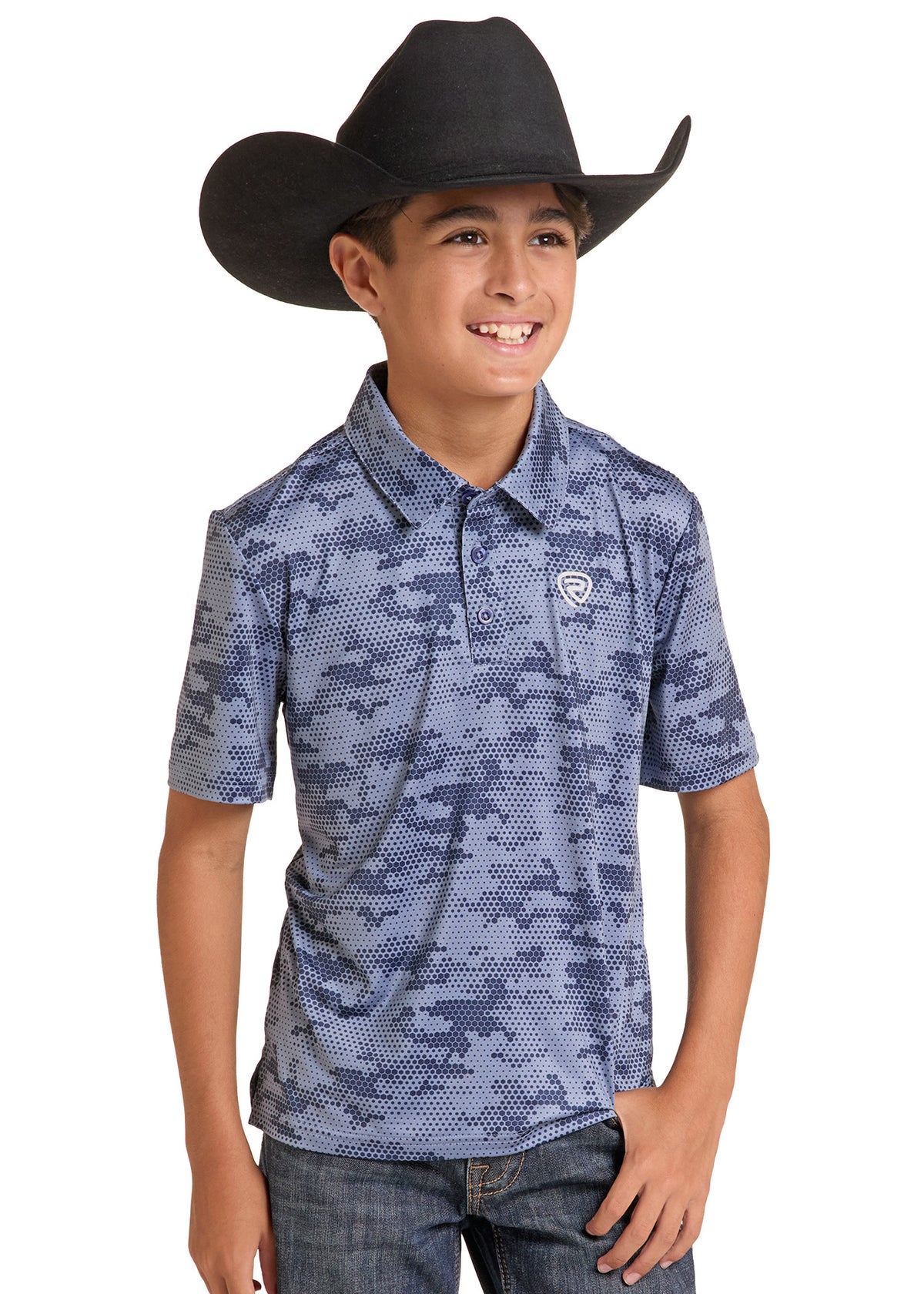 A young boy wearing a blue and gray digital camouflage polo shirt with a small shield logo on the chest, paired with a black cowboy hat and jeans, photographed against a solid white background.