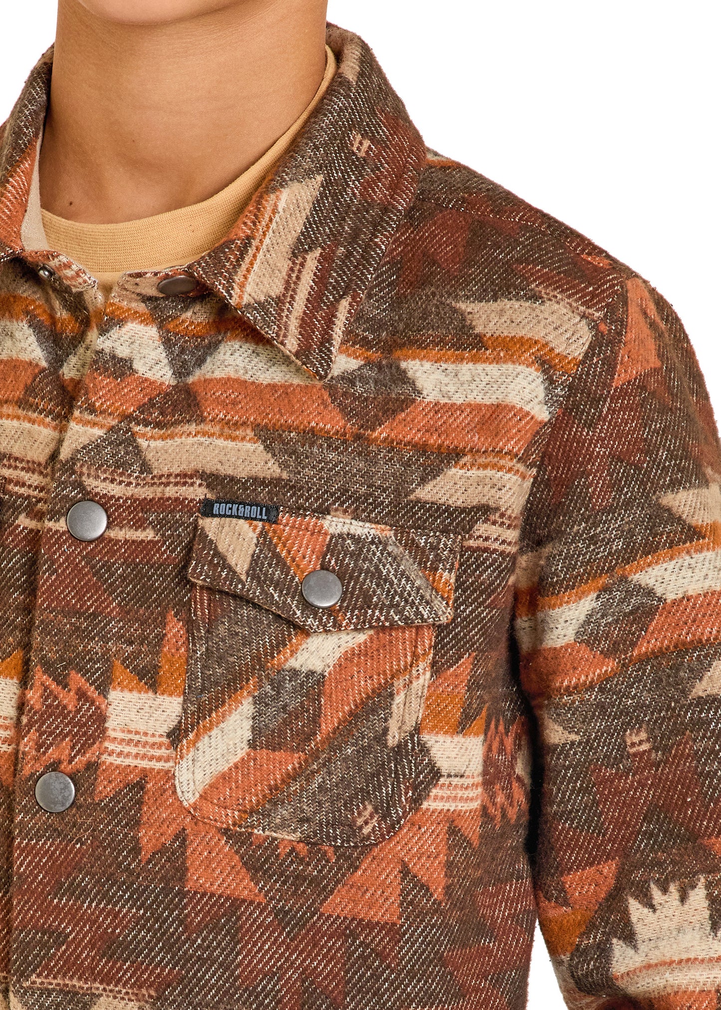 Close-up of a patterned jacket with a brand label on a neutral background