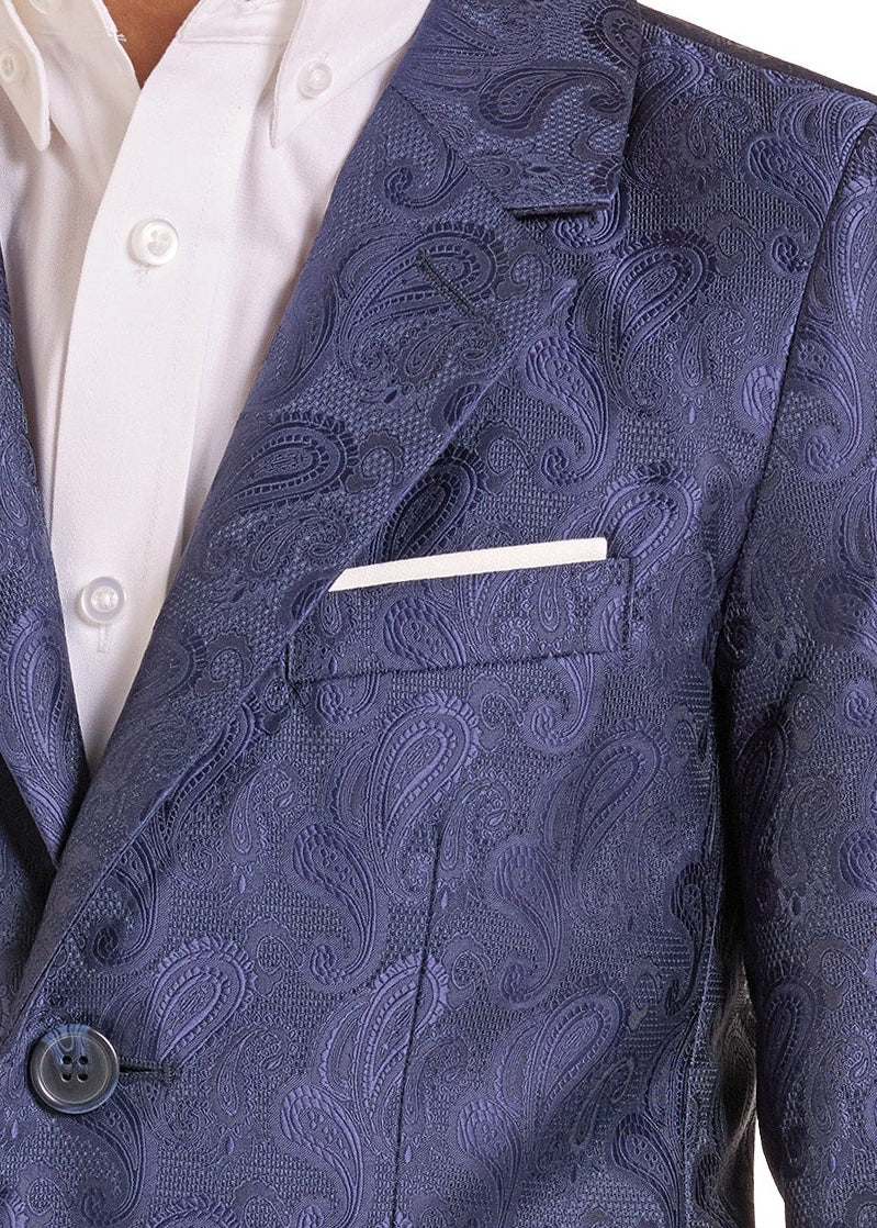 A boys' blue paisley jacquard blazer worn over a white collared shirt, shown from the chest down on a white background.