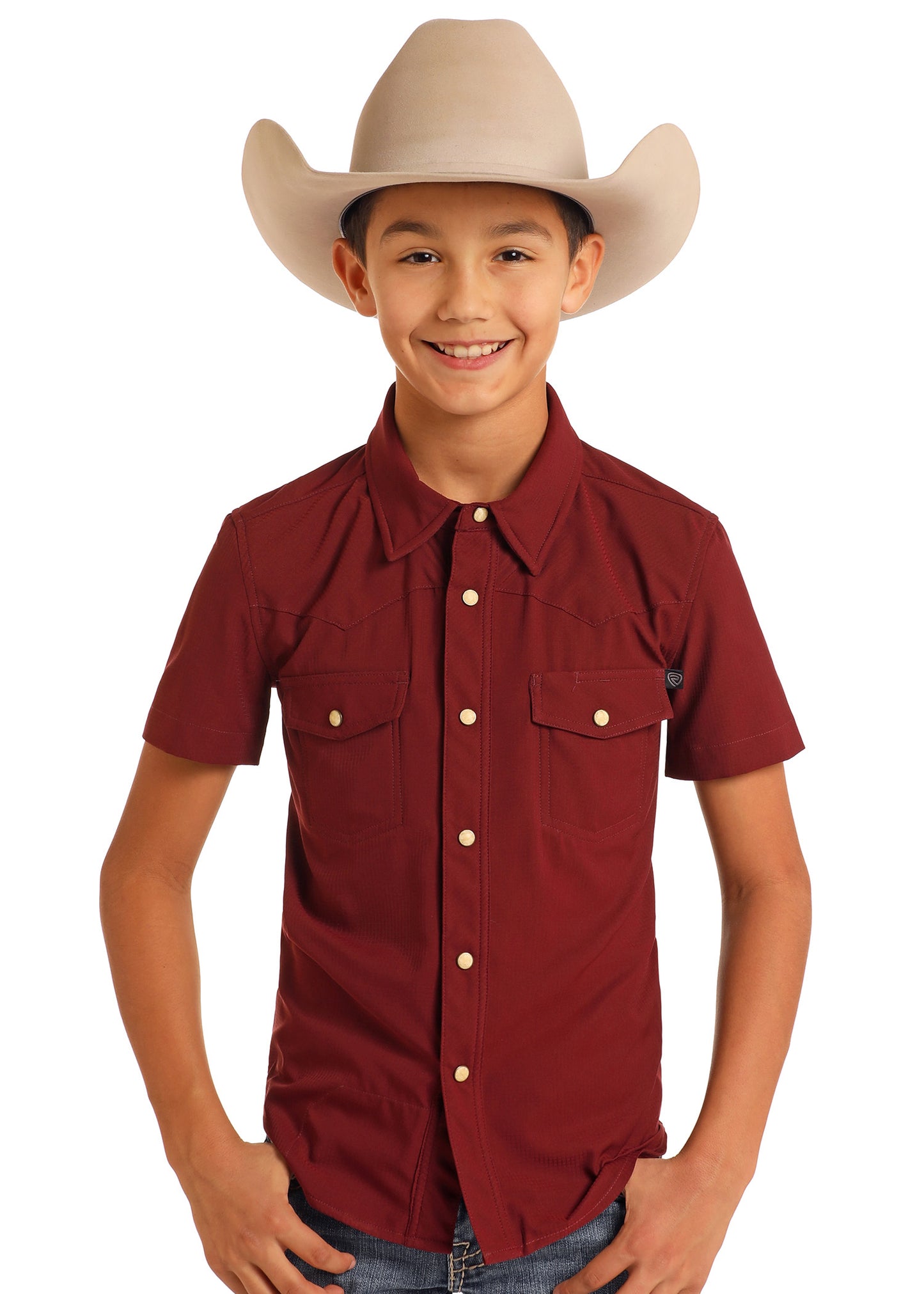 Child wearing a maroon shirt and beige cowboy hat on a white background