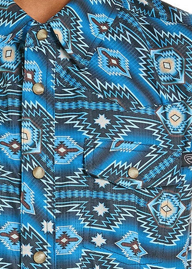 Close-up of a blue patterned shirt with pearl snaps.