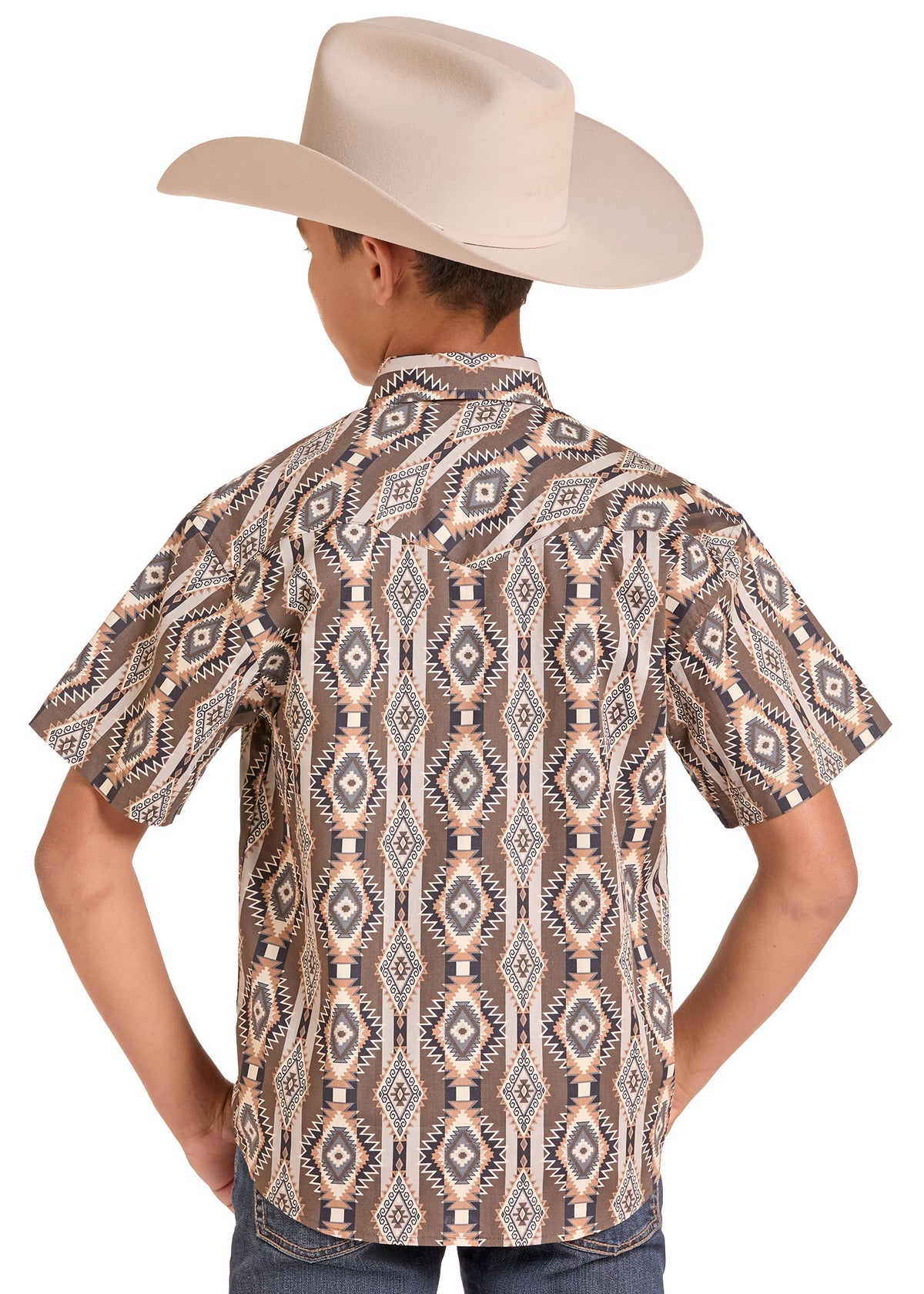 A boy wearing a beige cowboy hat and a short-sleeve button-up shirt with a brown, beige, and white geometric pattern, shown from the back against a white background.