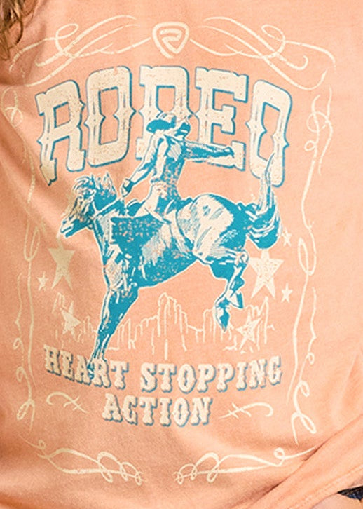 Young girl wearing a peach t-shirt with a graphic design and a cowboy hat on a white background