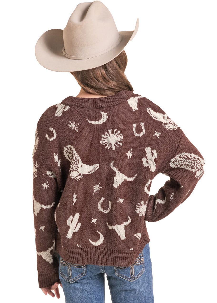 The back of a brown knit sweater with a cream western pattern, blue jeans, and a beige cowboy hat, set against a plain white background.