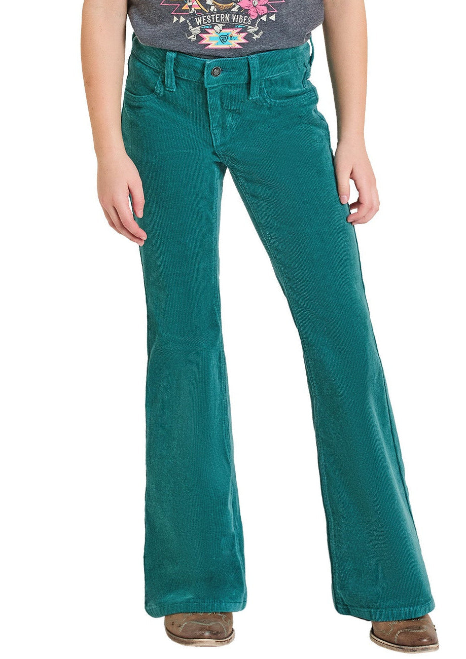 Child wearing a t-shirt and teal Corduroy jeans on a white background