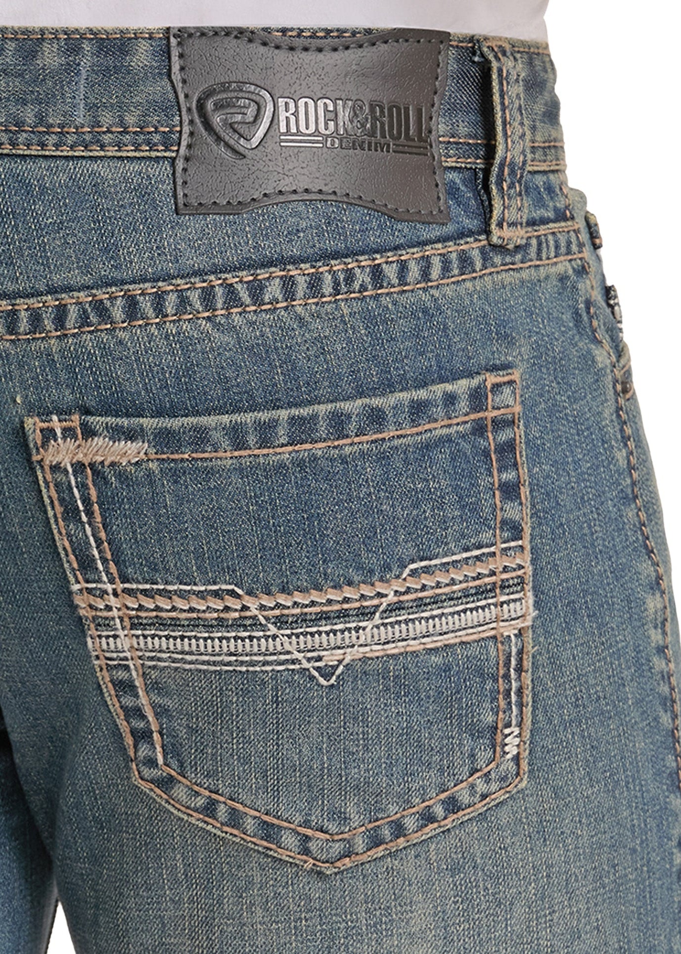 Close-up of the back waistband and pocket area of blue denim jeans, showing a dark gray Rockroll brand patch and contrast tan stitching.