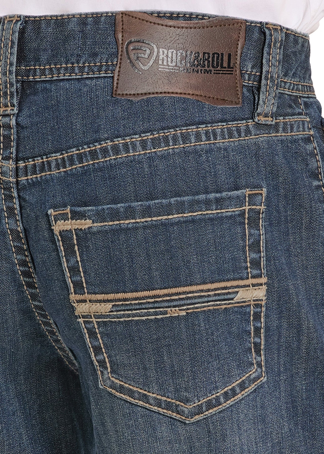 Close-up of blue jeans with a Rock & Roll leather patch on the back pocket.