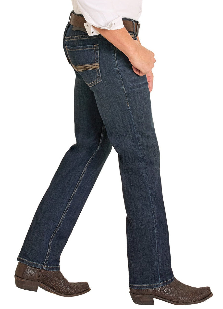 Person wearing blue jeans and brown boots on a white background