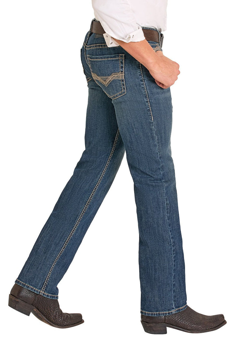 Person wearing blue jeans and brown boots on a white background