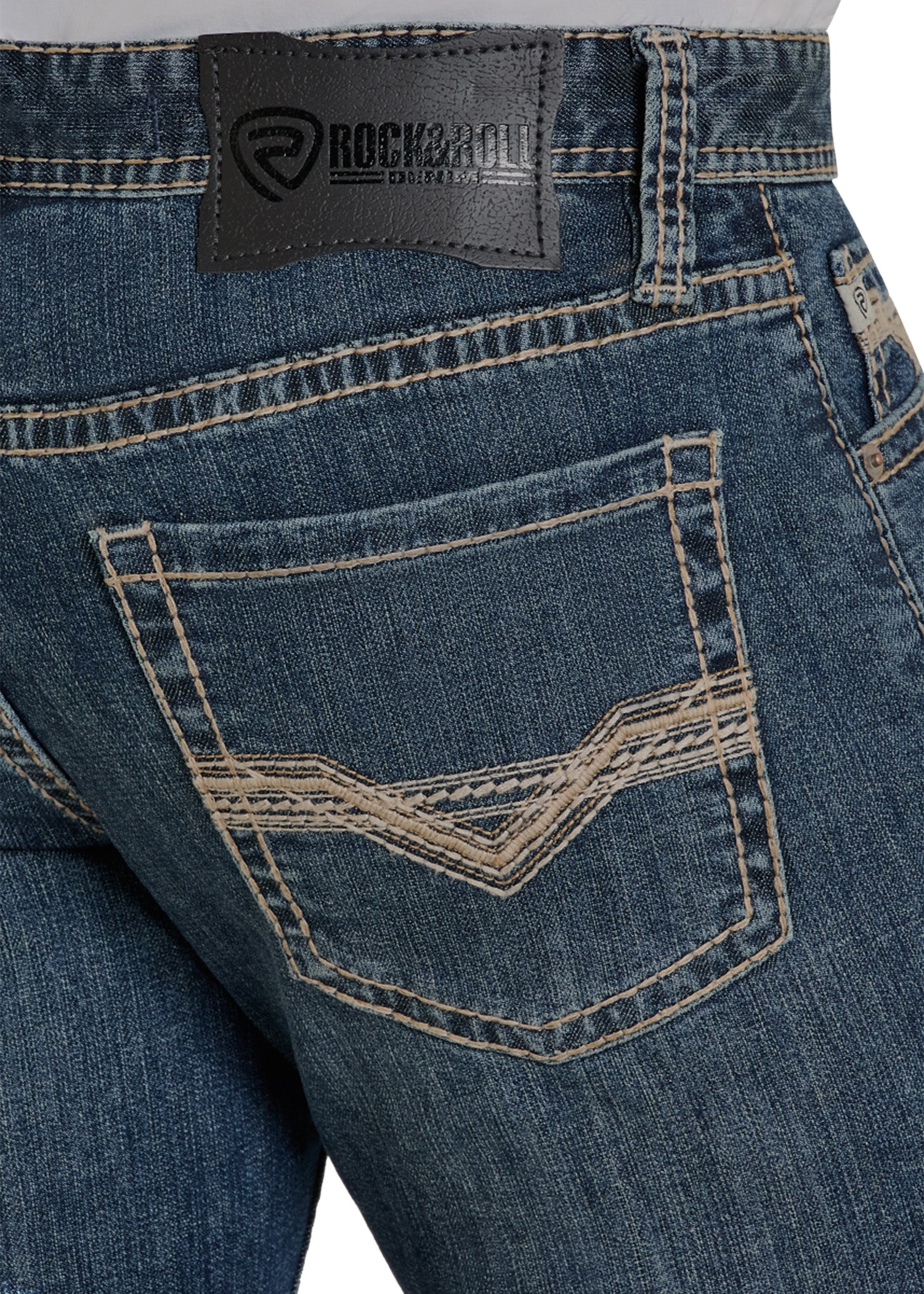 Close-up of blue jeans with a brand label on a white background