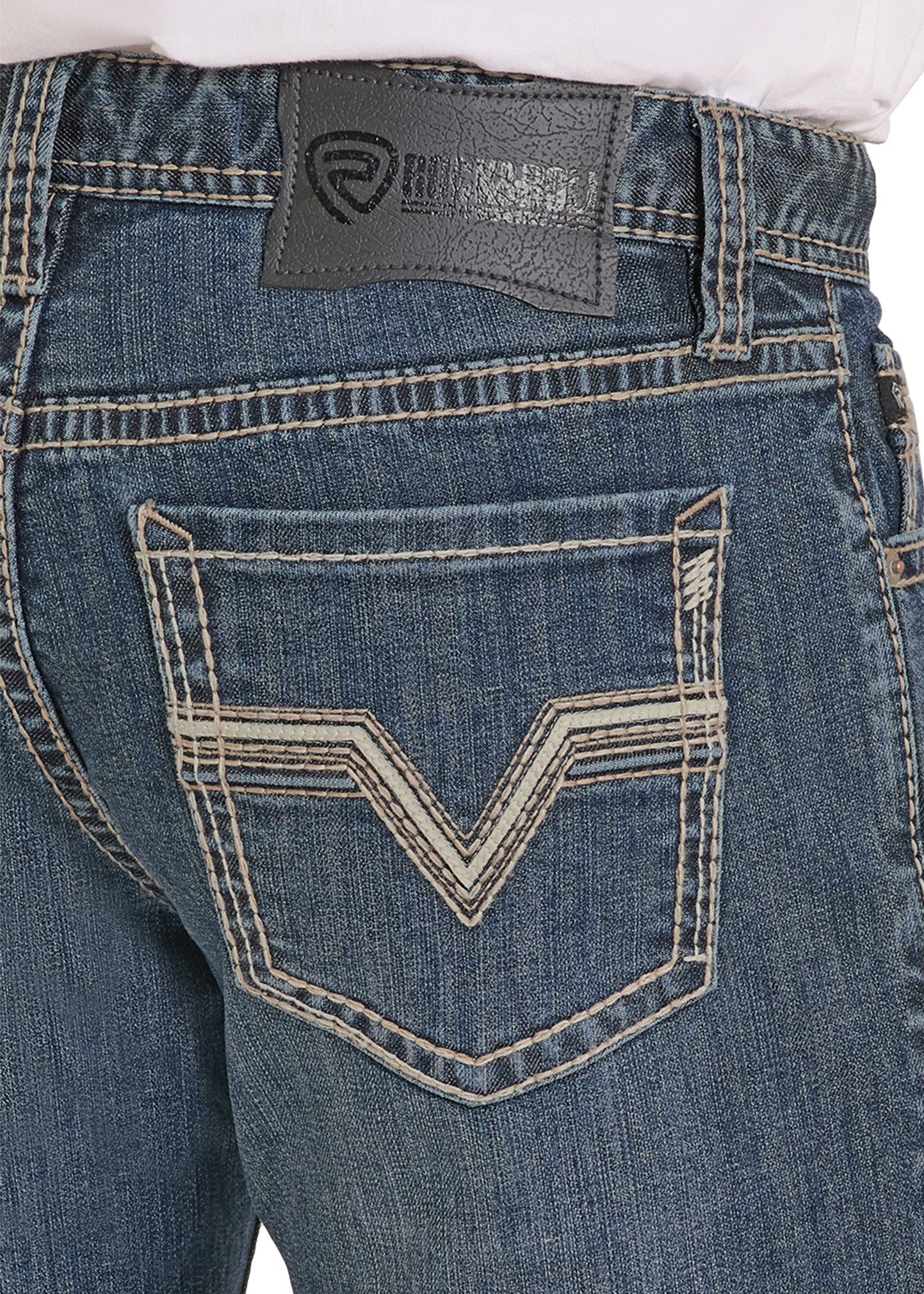 Close-up of blue jeans with a brand logo on the pocket area.