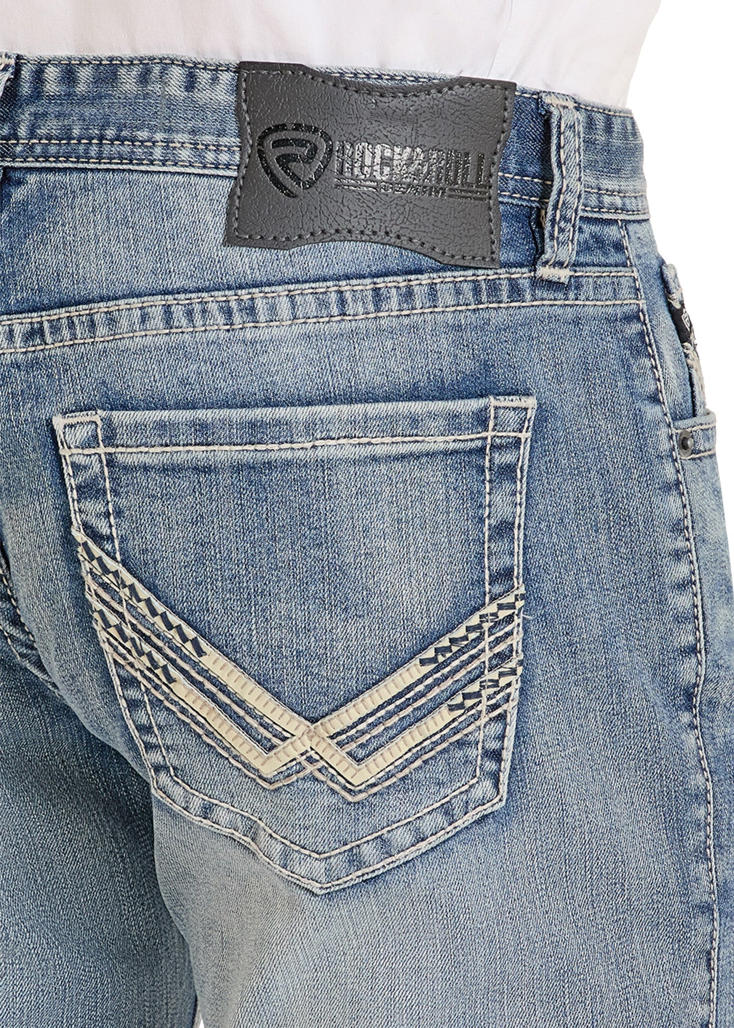 Close-up of blue jeans with a brand label on the back pocket against a white background