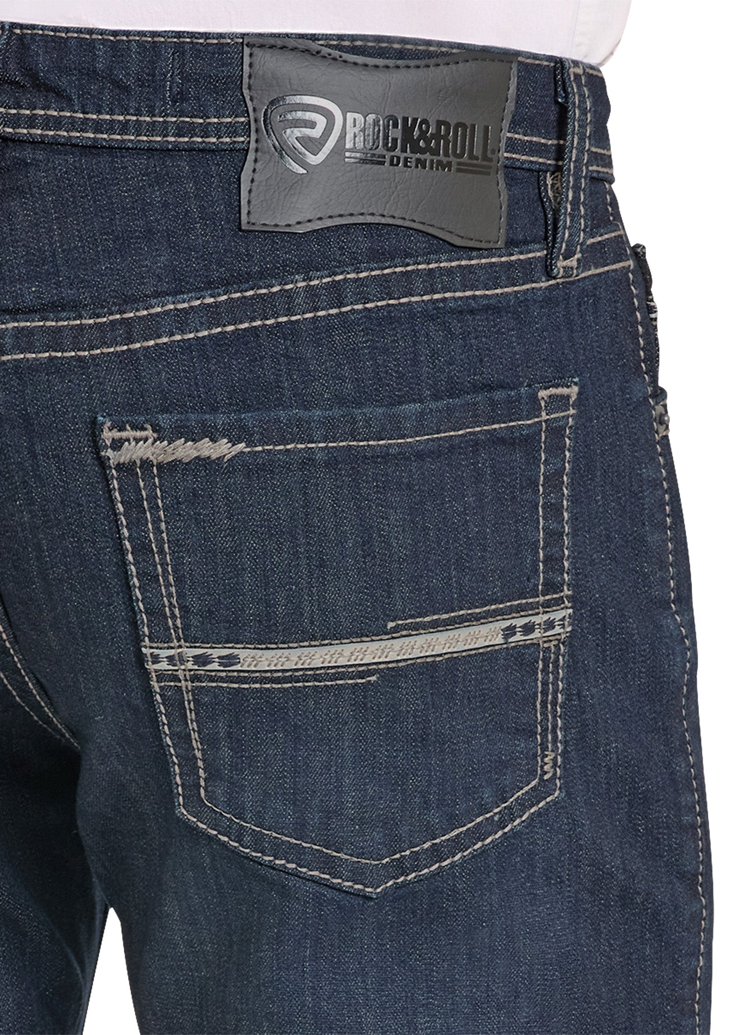 Close-up of blue jeans with a visible brand label on a white background