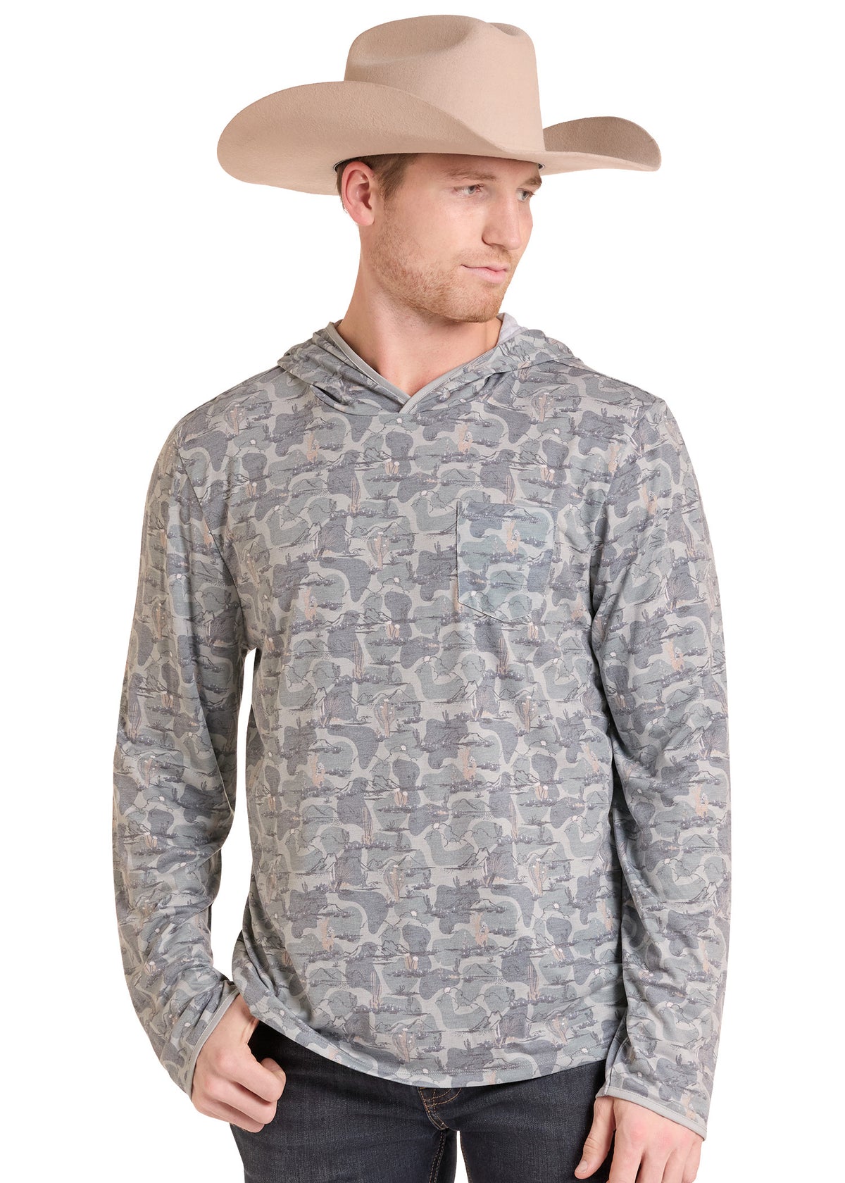 A man wearing a beige cowboy hat and a gray camouflage long-sleeve hooded shirt, standing against a plain white background.