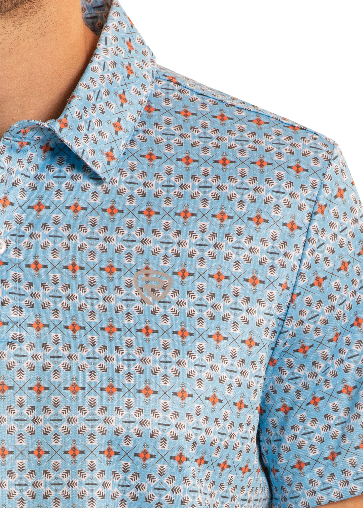 Close-up of a blue patterned shirt with geometric designs.