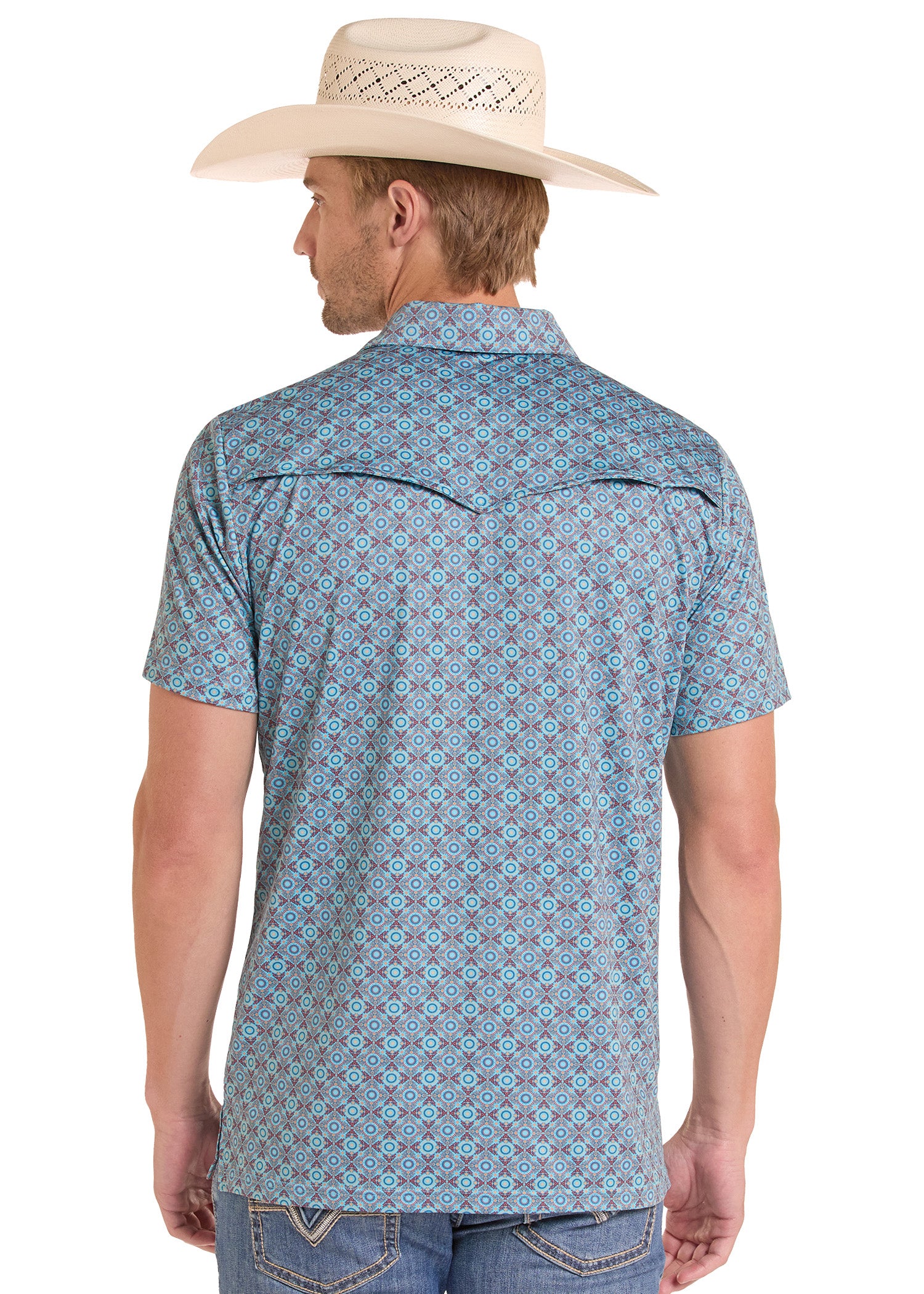 Man wearing a blue patterned shirt and beige cowboy hat on a white background