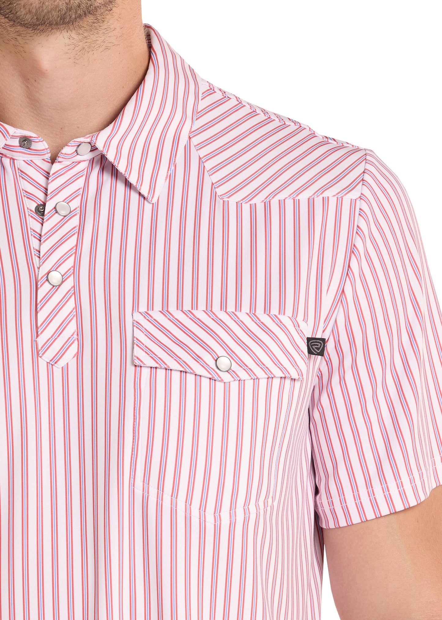 Close-up of a person wearing a pink and white striped shirt with a pocket.