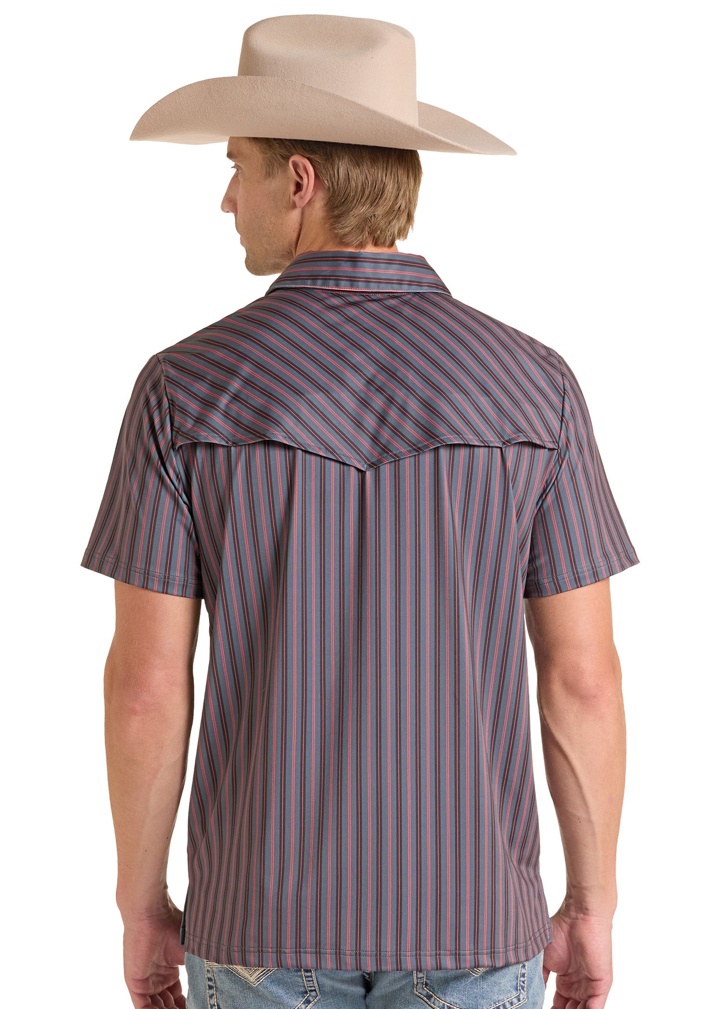 A man shown from the back wearing a short-sleeve western shirt with vertical stripes in muted purple, blue, and red, paired with a beige cowboy hat and light blue jeans, against a plain white background.