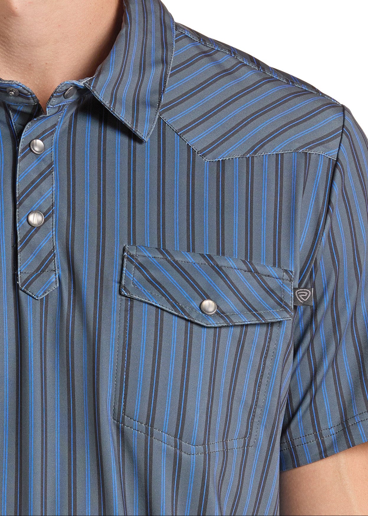 Close-up of a man wearing a short-sleeve western-style button-up shirt with vertical blue, gray, and black stripes, featuring a chest pocket with a silver snap button.