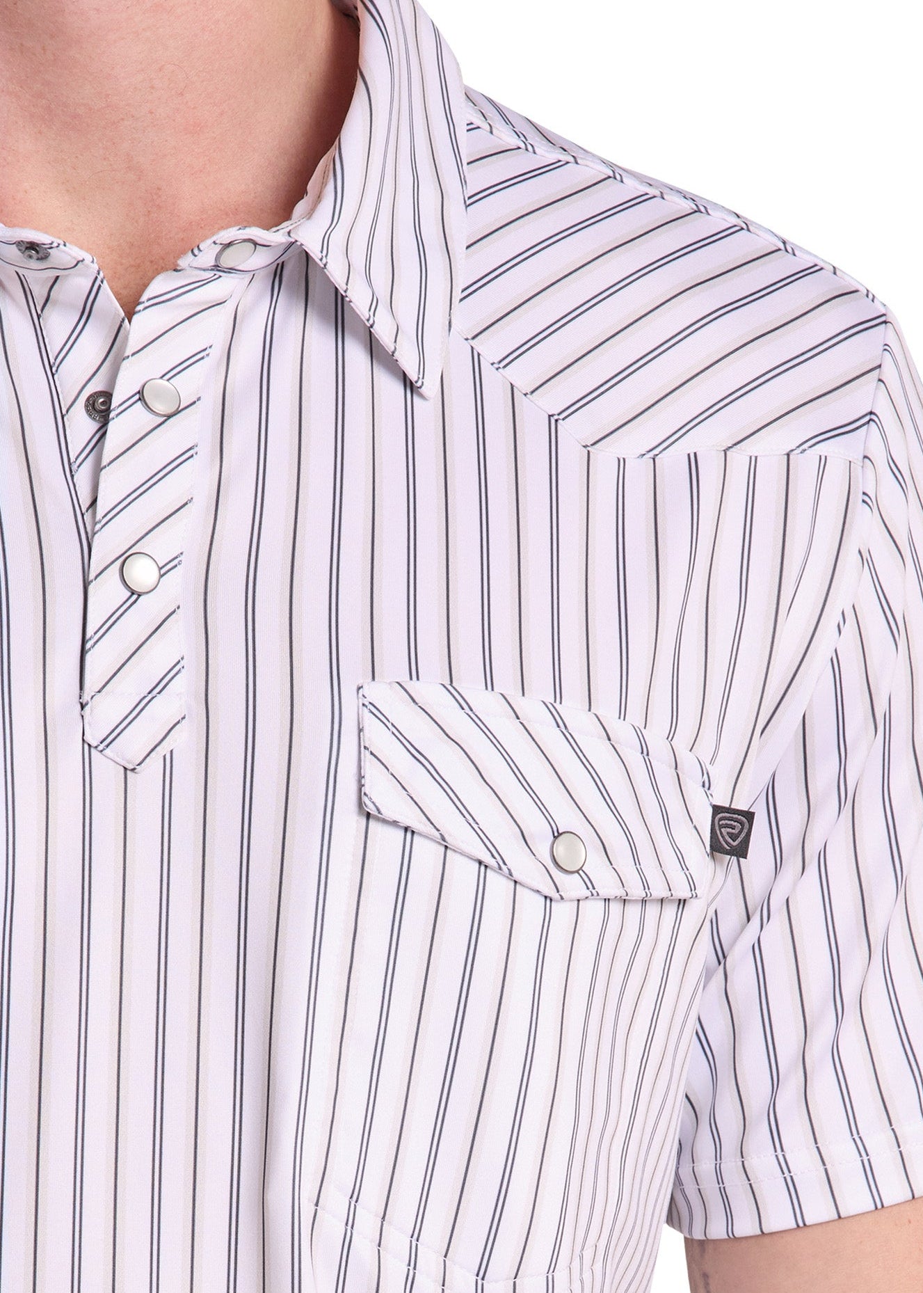 Close-up of a men's short-sleeve button-up shirt with vertical navy blue pinstripes on a white base, featuring a chest pocket with a snap closure and a small brand tag.