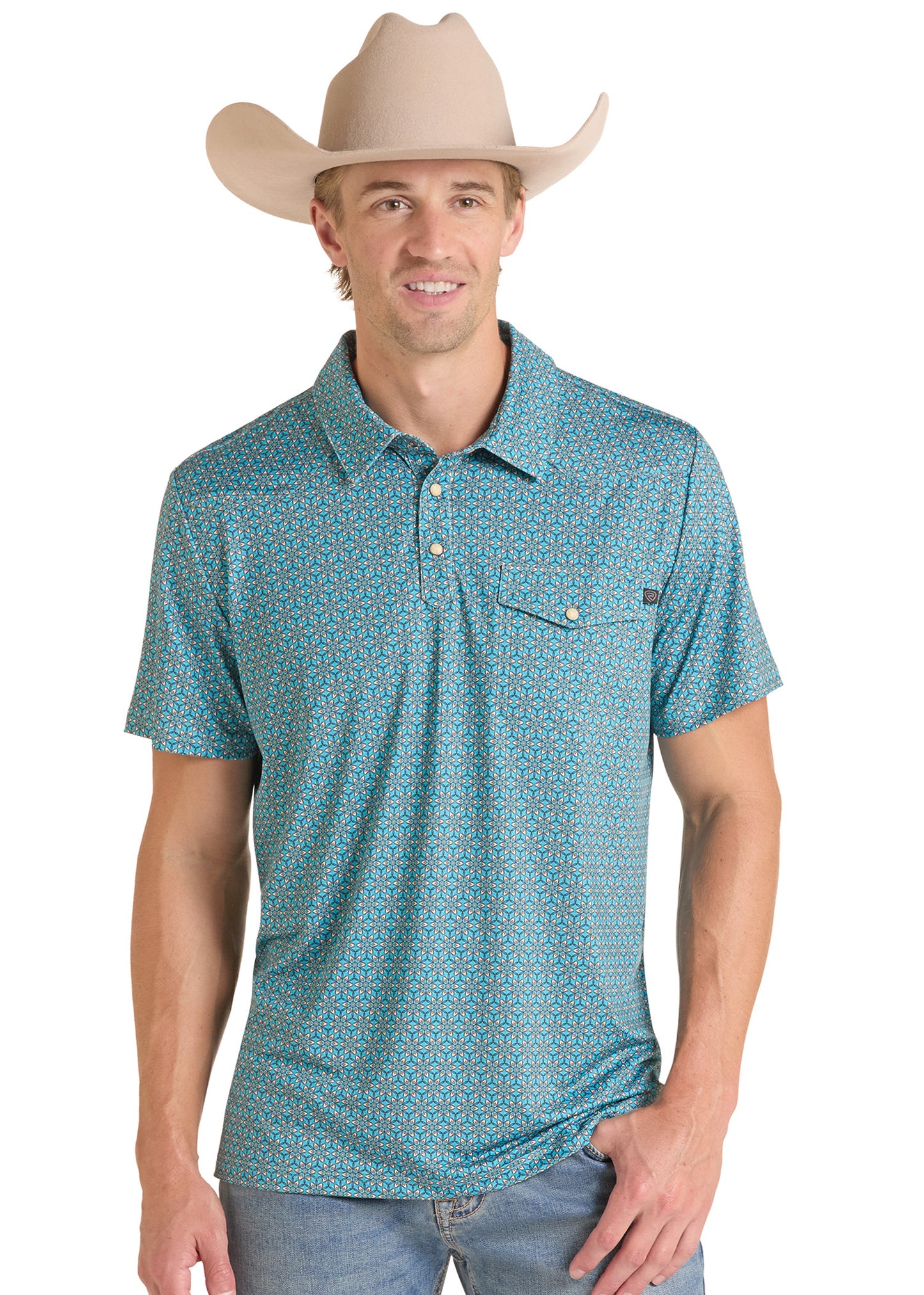 A man wearing a turquoise and blue patterned short-sleeve polo shirt with a cowboy hat and jeans, photographed against a plain white background.