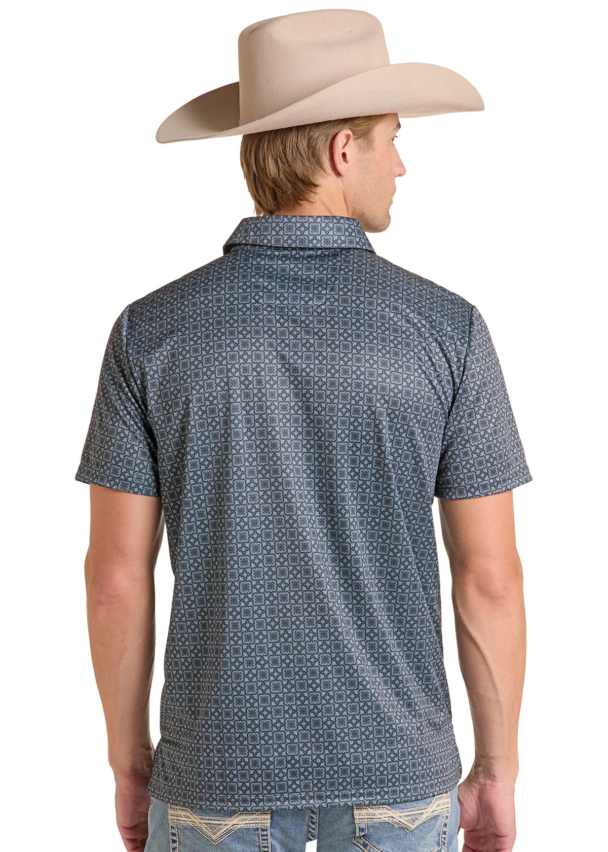 A man shown from the back wearing a short-sleeve western-style button-up shirt with a small geometric pattern in blue and white, paired with a beige cowboy hat and light blue jeans, against a plain white background.