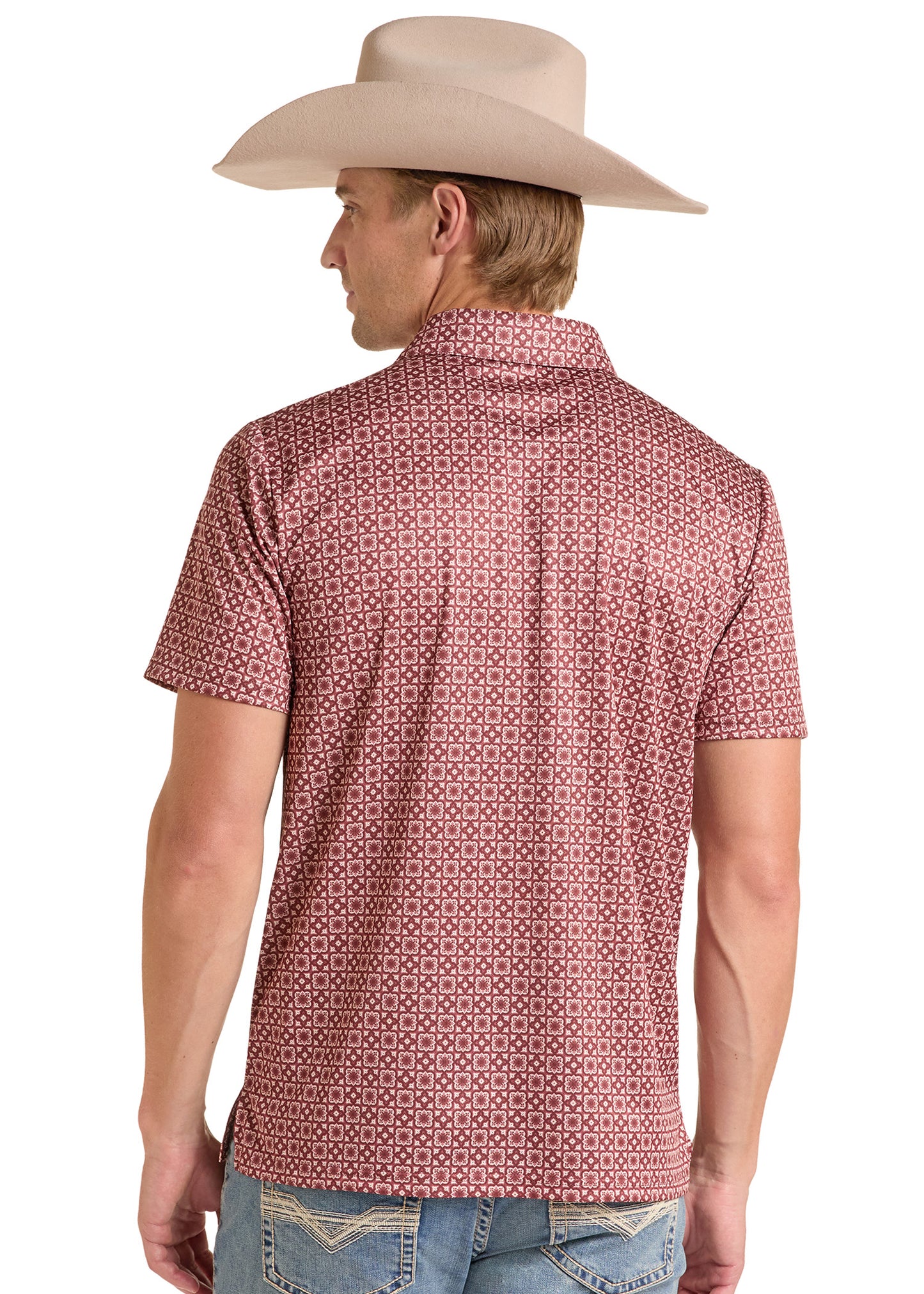 A man wearing a light beige cowboy hat and a short-sleeve collared shirt with a small repeating geometric pattern in pink and white, shown from the back against a plain white background.