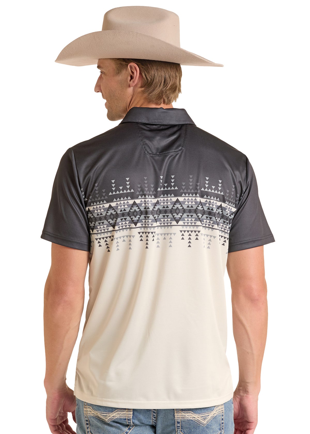 A man wearing a short-sleeve polo shirt from the back, featuring a dark gray upper section and a cream-colored lower section with a black geometric pattern across the middle. He is also wearing a beige cowboy hat and blue jeans, set against a plain white background.