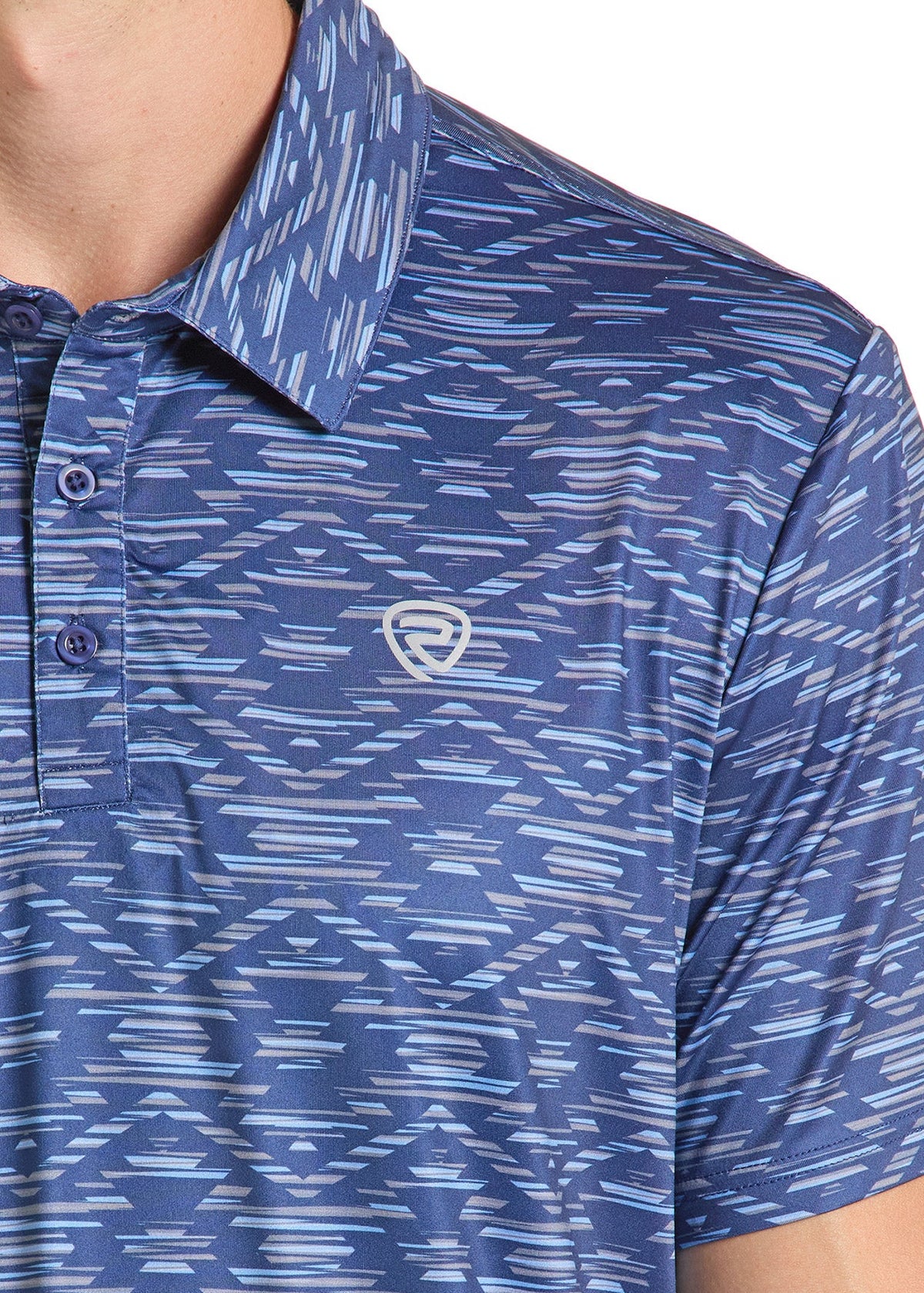 Close-up of a blue patterned short-sleeve polo shirt worn by a model, featuring an abstract white and light blue dash pattern and a small shield logo on the left chest.