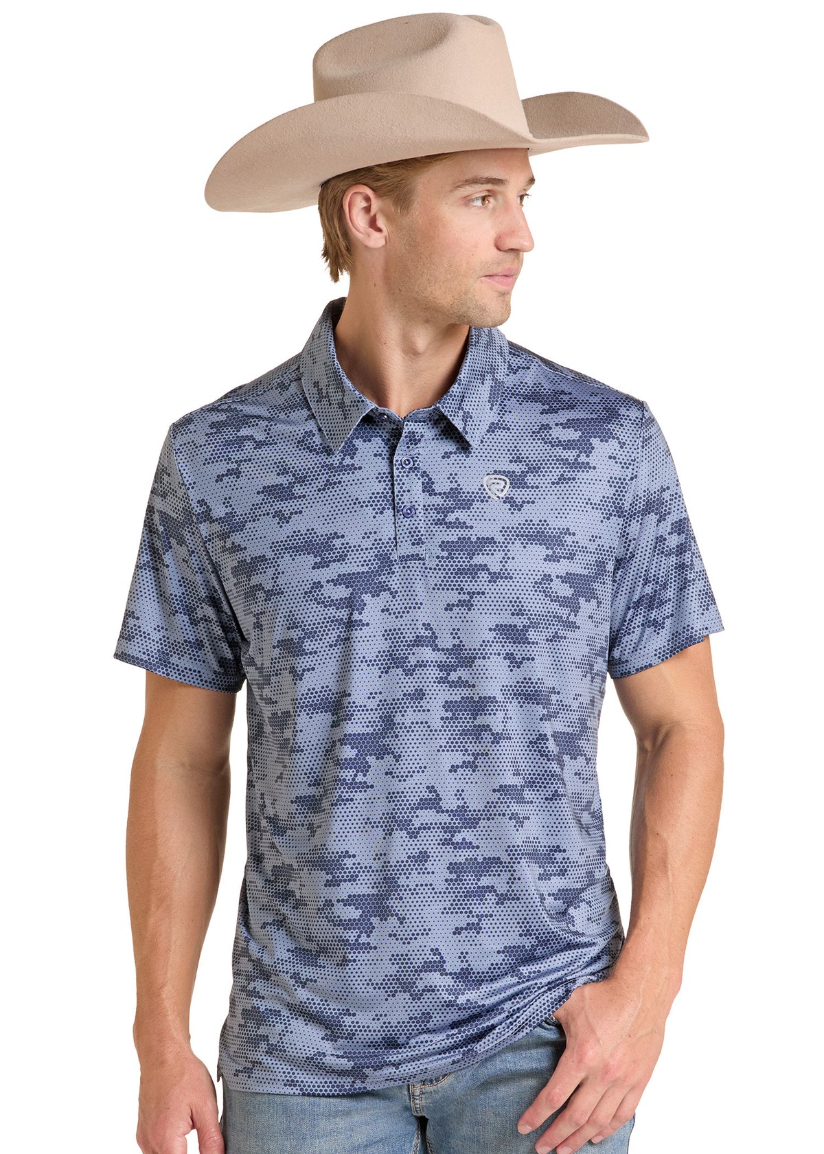 A man wearing a blue and gray digital camouflage polo shirt with a small embroidered logo on the chest, paired with a beige cowboy hat and blue jeans, set against a plain white background.