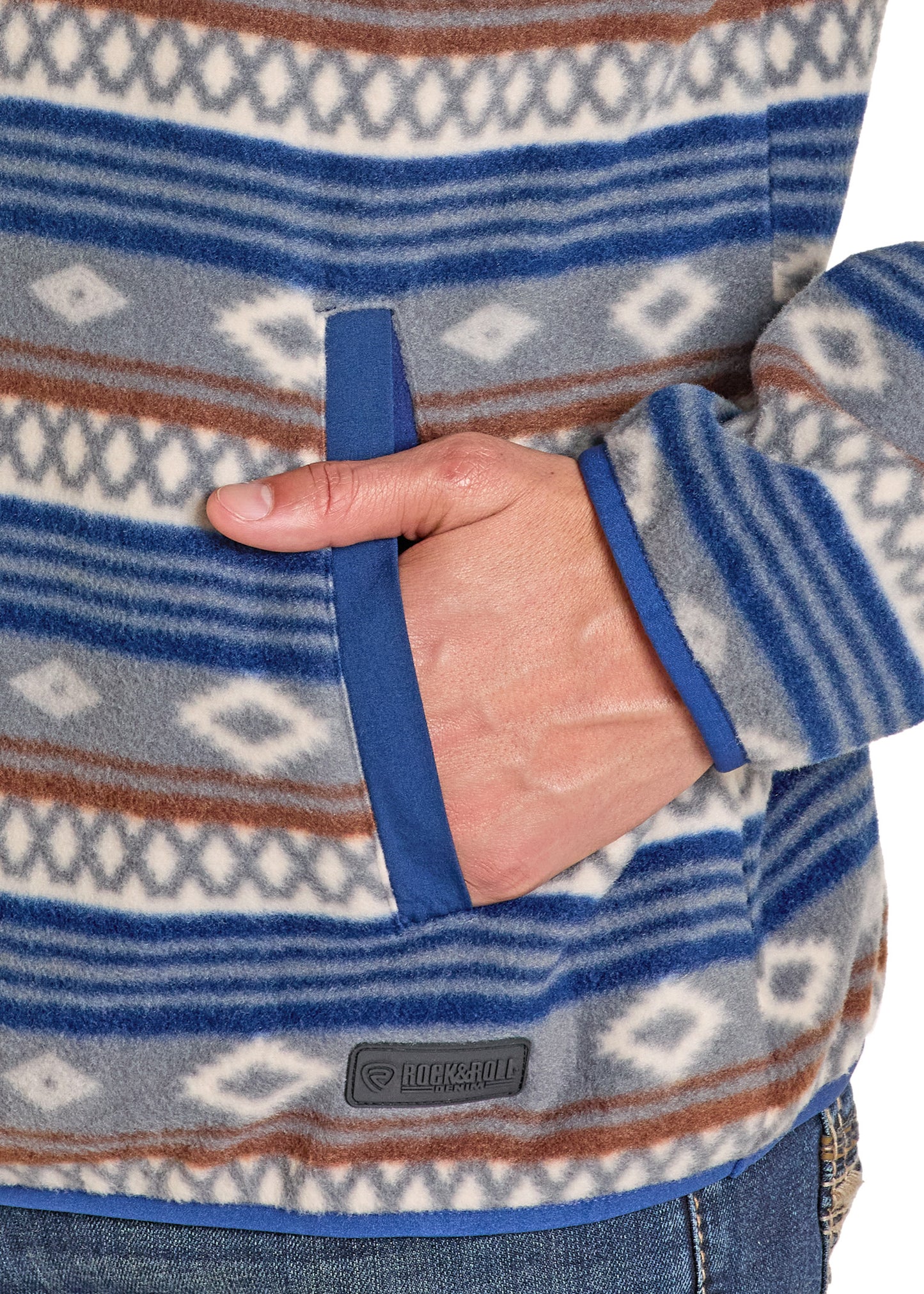 Close-up of a patterned fleece jacket with a brand logo on a white background